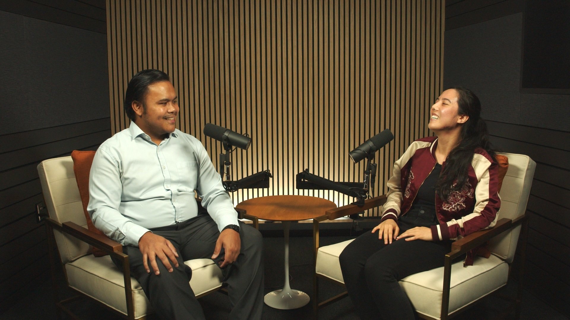 Two people recording a video podcast in lounge chairs on The Burnside set at Studio TwentyOneTwelve in Portland.