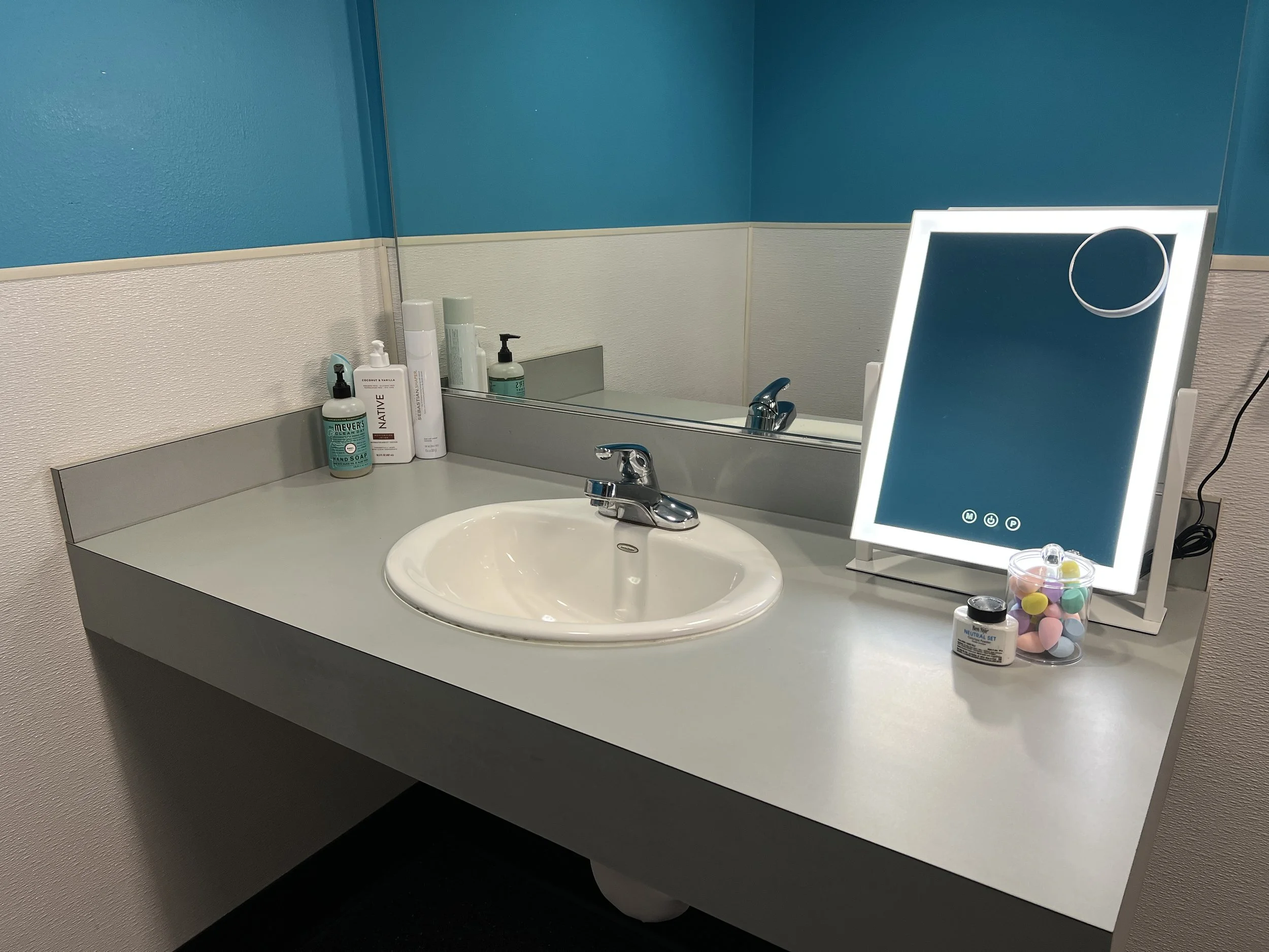 Dressing room with a lighted makeup mirror at Studio TwentyOneTwelve