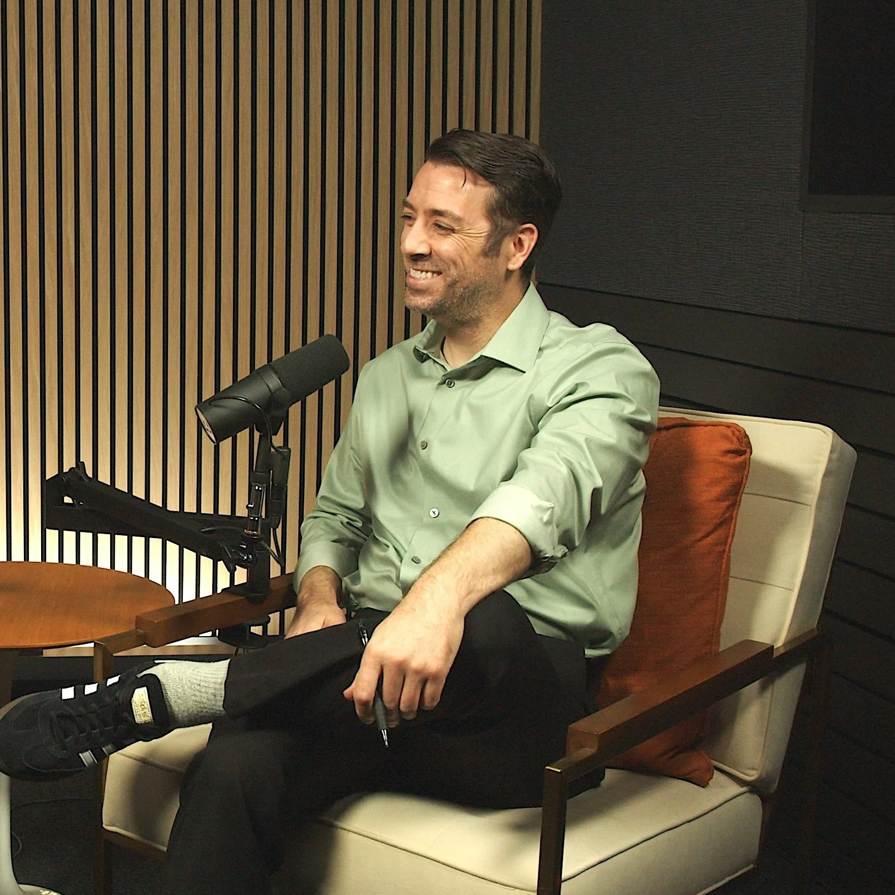 Podcast guest smiling at the mic during a video podcast recording at Studio TwentyOneTwelve in Portland