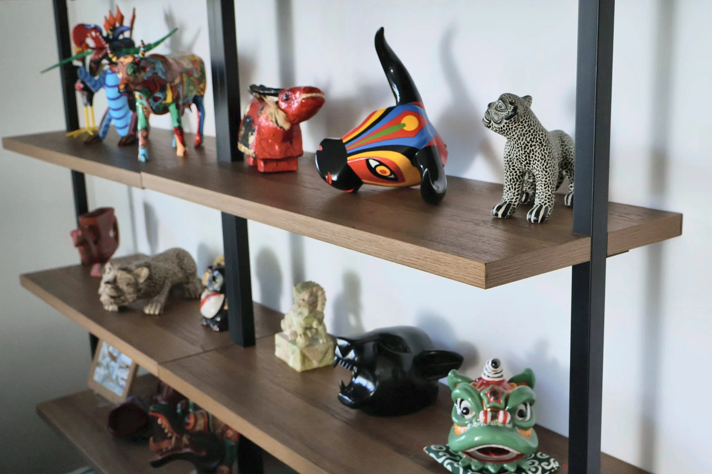 Floating wood shelves displaying colorful folk art