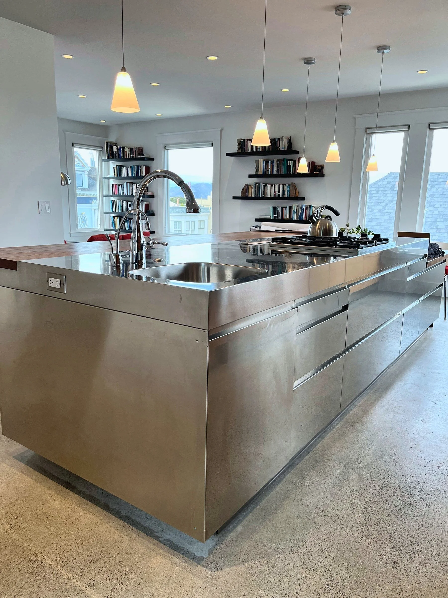 Kitchen with stainless steel island and open shelving