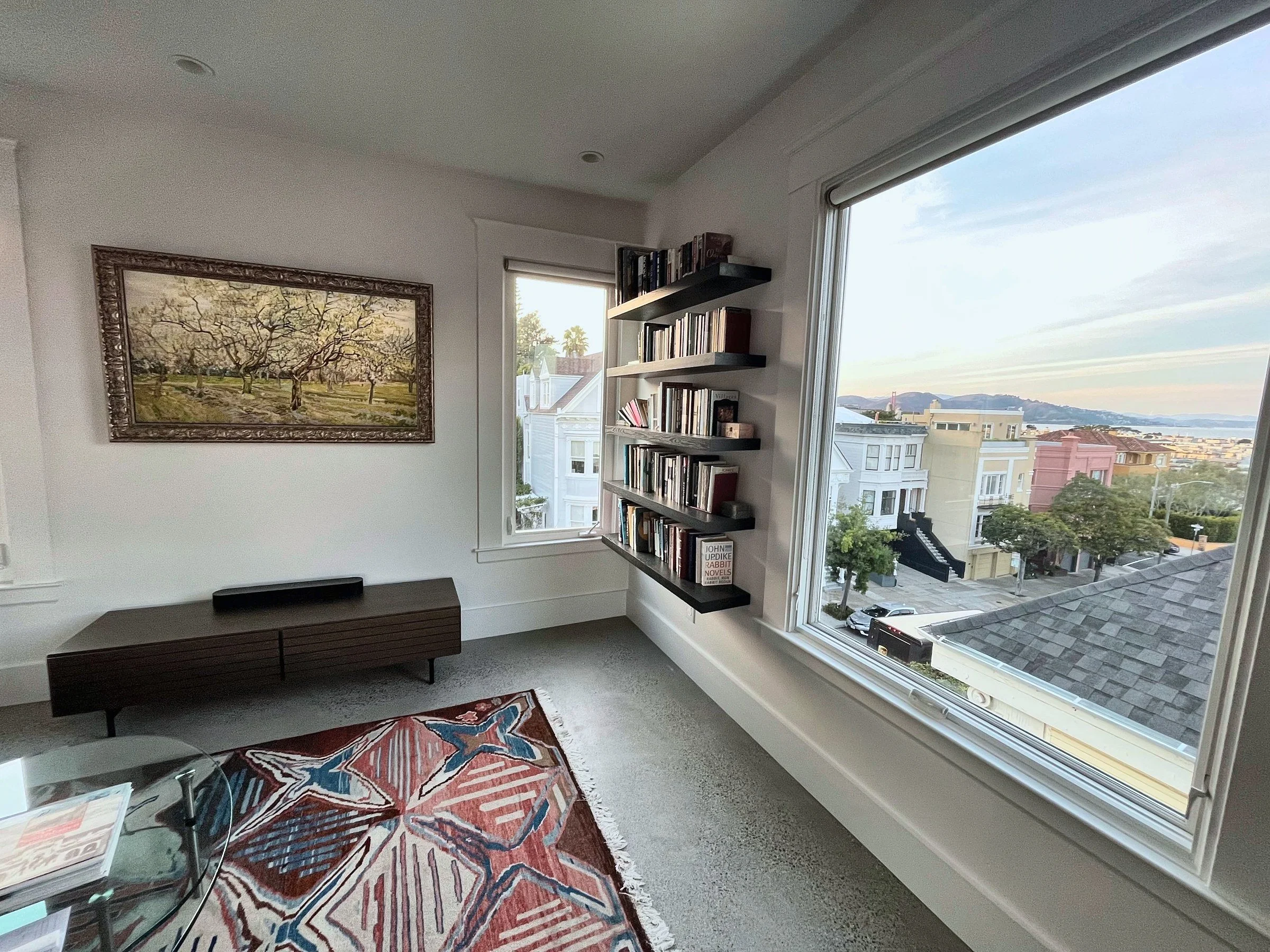 Sunlit San Francisco living room with floating shelves and bay window