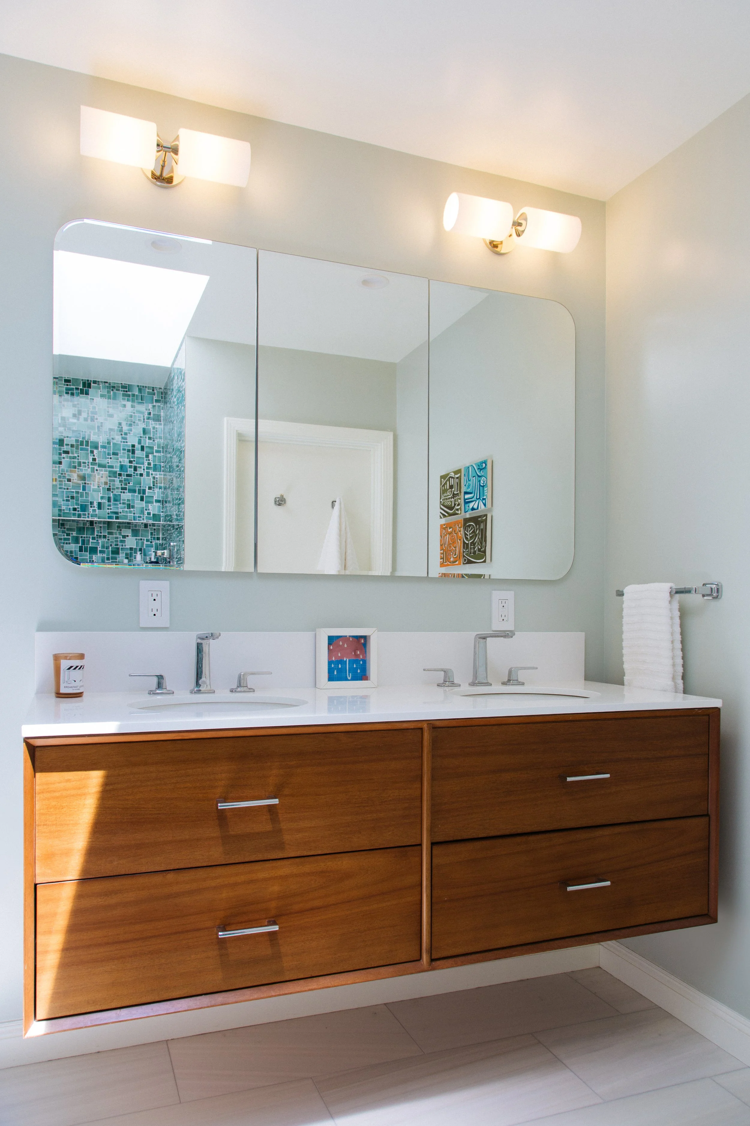 Bathroom with walnut double vanity and mirrored medicine cabinets in San Francisco