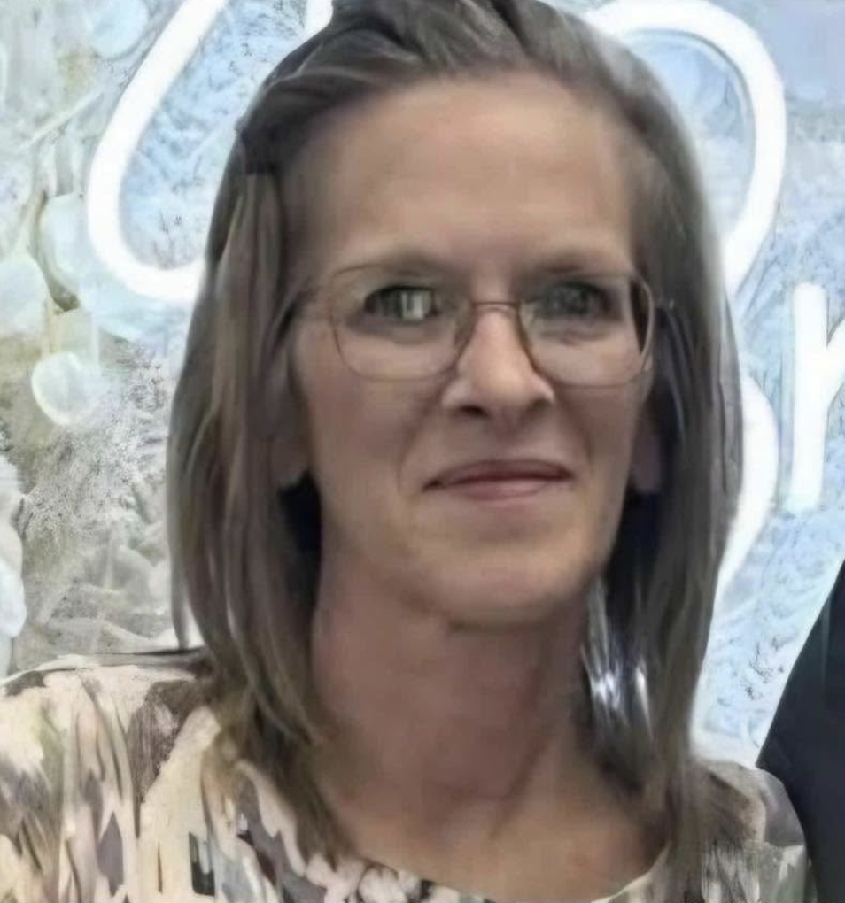 picture of a smiling woman in glasses
