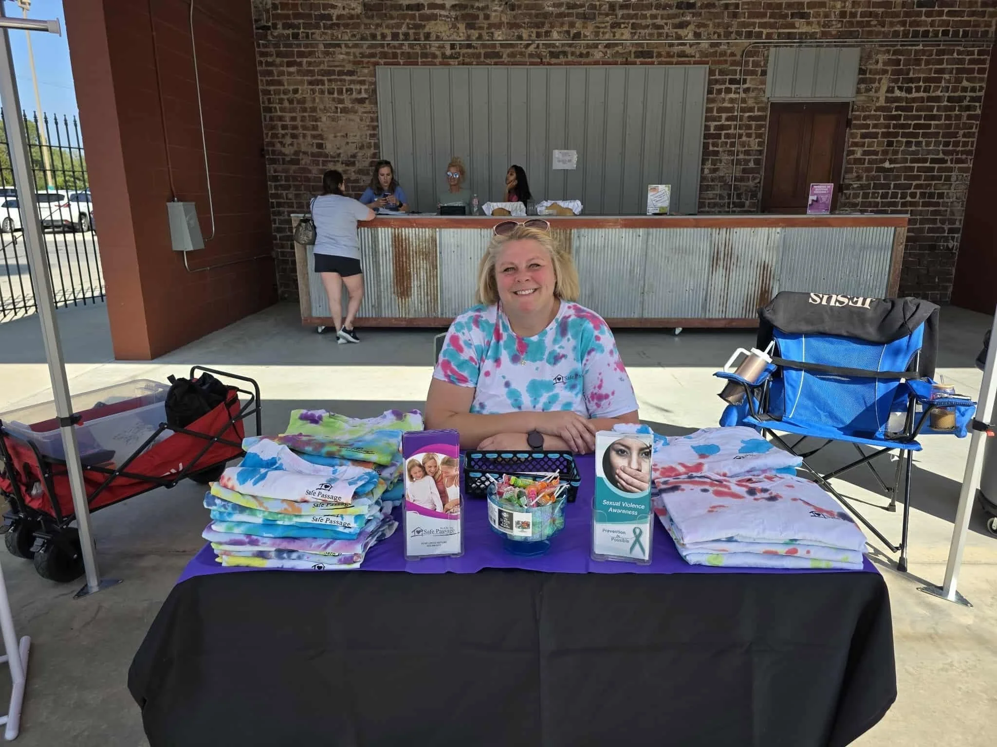 Image of a woman sitting at an Information Booth