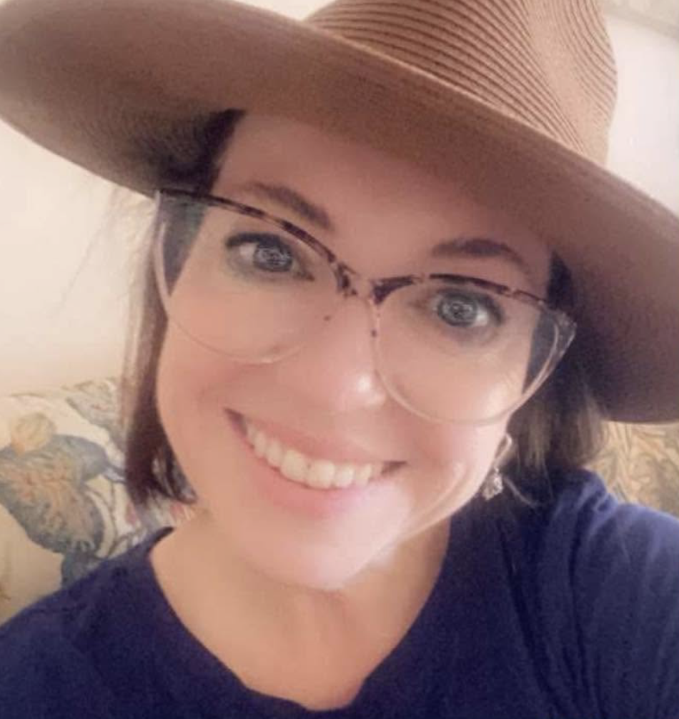 Picture of woman in hat with glasses and a big smile
