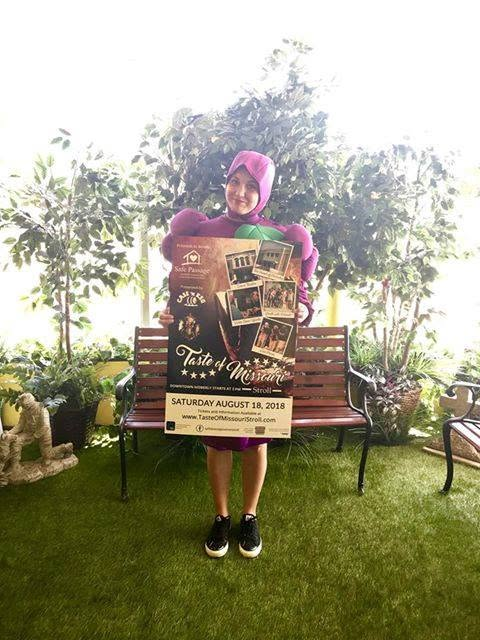 Image of woman holding a sign