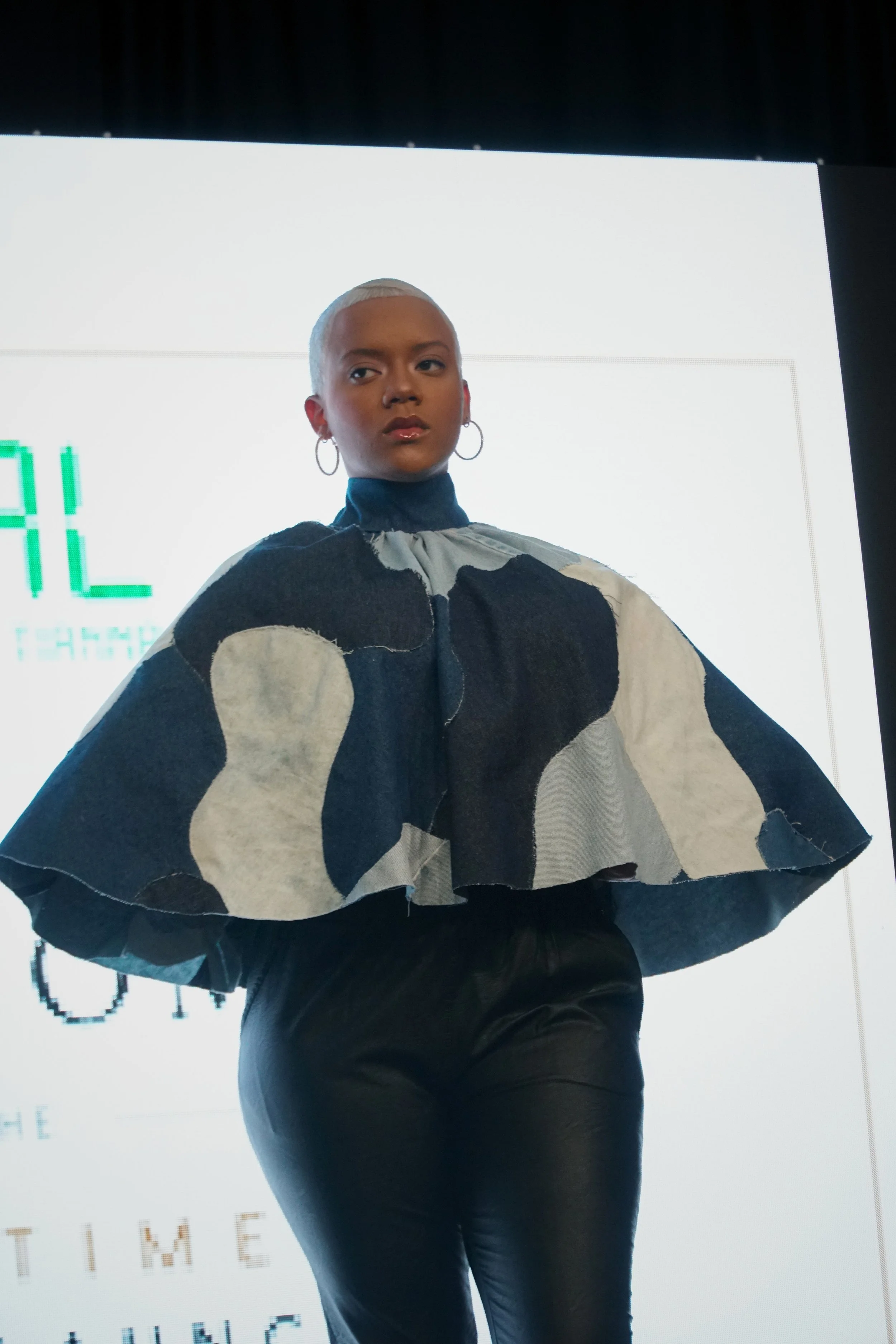 This cape was constructed from a handmade textile created from upcycled denim. Each shape was hand-cut, sewn, and draped to form the final silhouette.