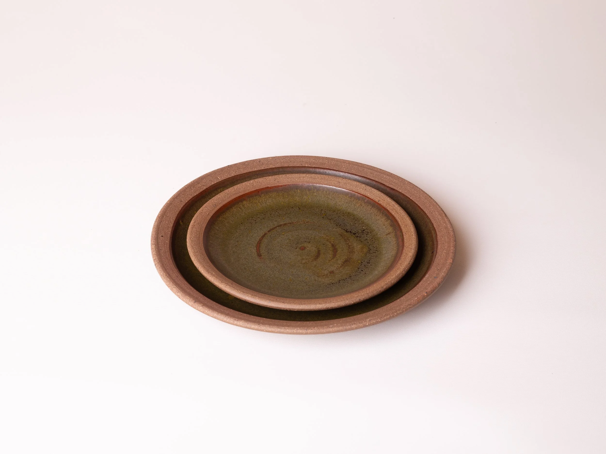 A set of three nested round ceramic bowls on a plain white background.