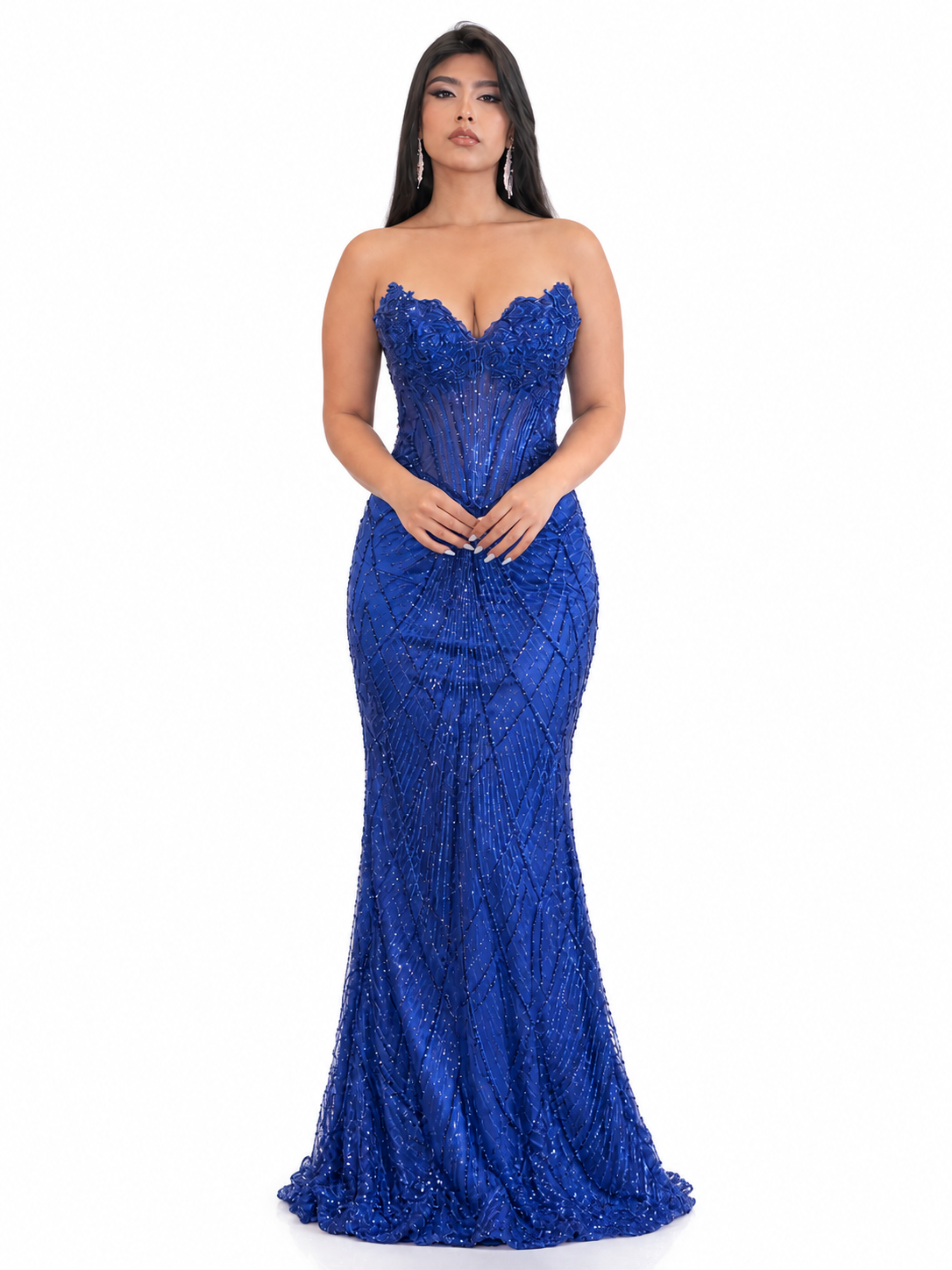 Woman in a long, elegant, blue evening gown with intricate beadwork, standing against a plain white background.