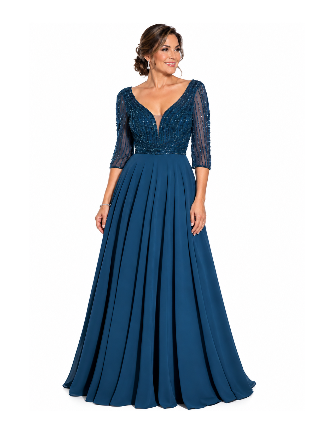 A woman in an elegant, dark blue gown with sheer three-quarter length sleeves and intricate beading on the bodice, standing against a plain white background.