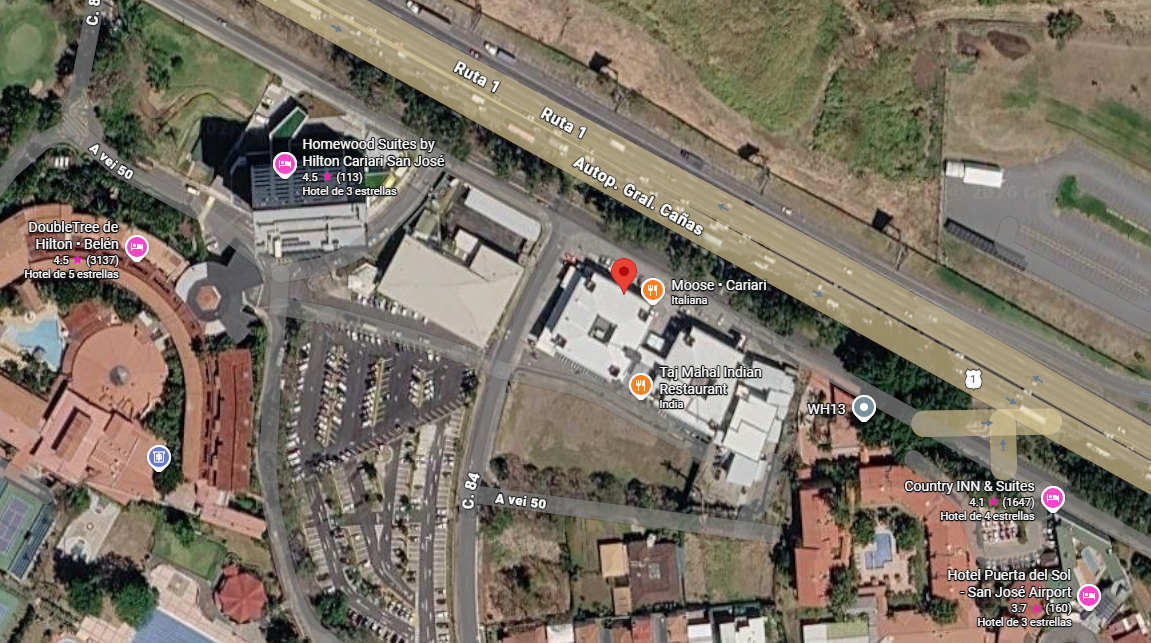 Satellite map showing a hotel, restaurant, parking lot, and roads near San José Airport.