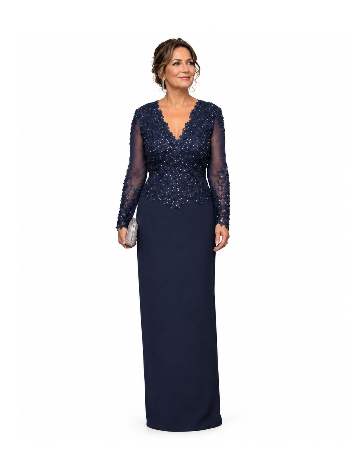 A woman in a navy blue formal gown with a lace and embellished top, holding a small clutch, standing against a white background.