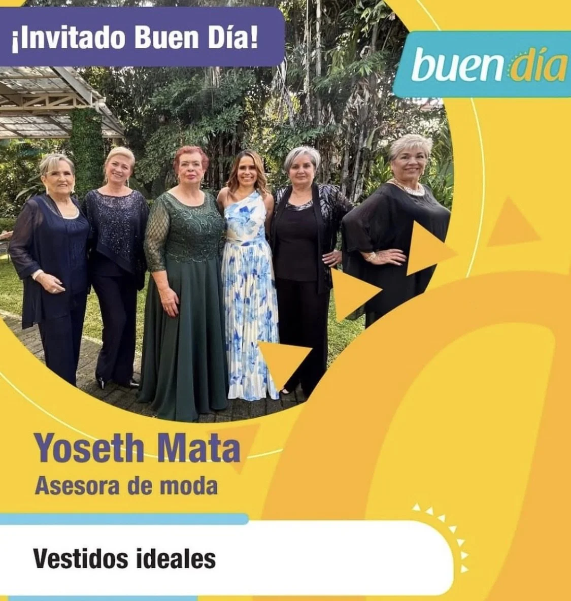 A group of six women standing outdoors in a garden with green foliage, dressed in evening clothes, smiling for the photo.