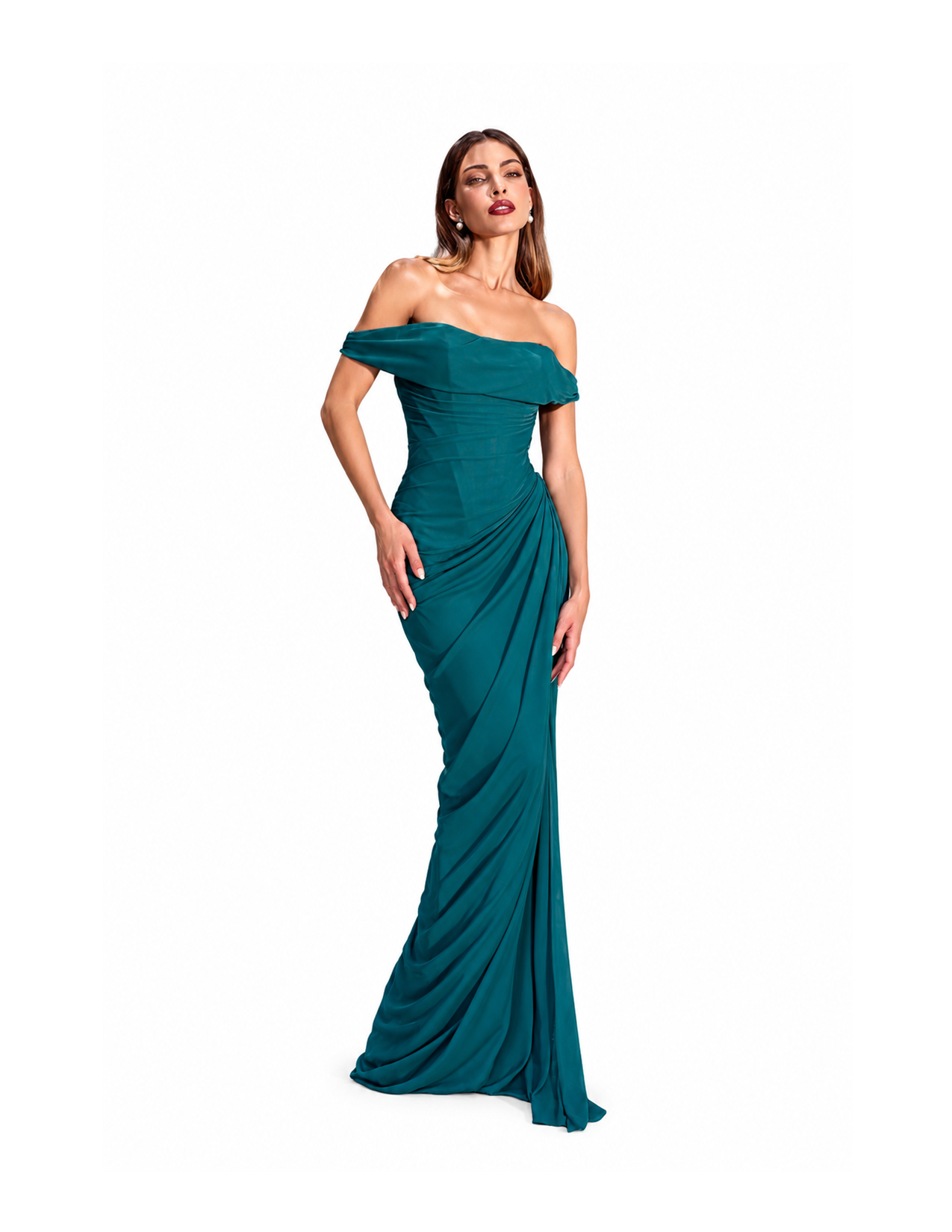 A woman wearing a strapless emerald green evening gown with a draped skirt, standing against a white background.