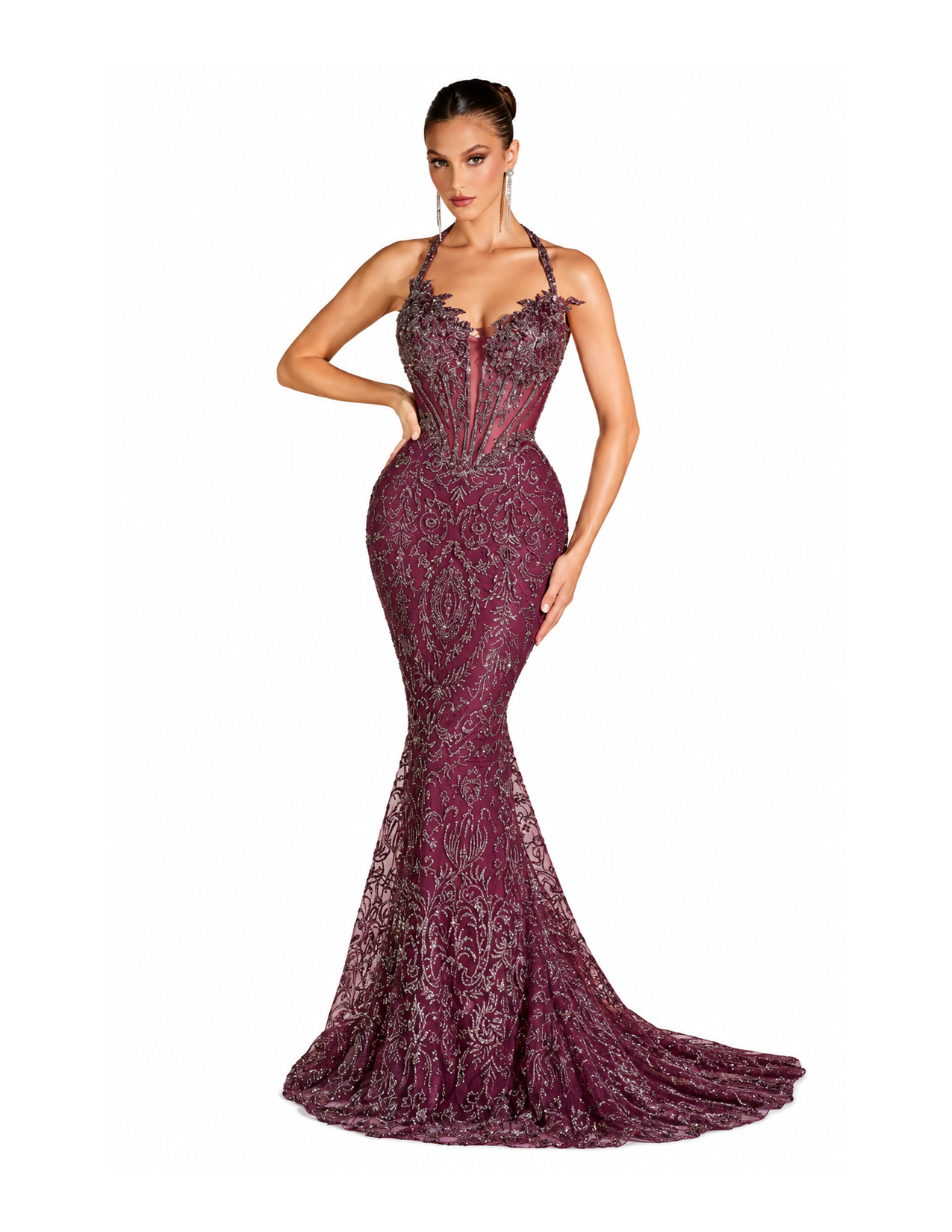 Woman wearing a form-fitting, embellished burgundy evening gown with a mermaid silhouette, intricate silver detailing, and a halter top, standing against a white background.