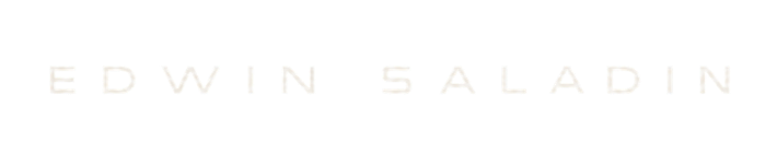 Text reading 'EDWIN SALADIN' in uppercase letters on a dark background.