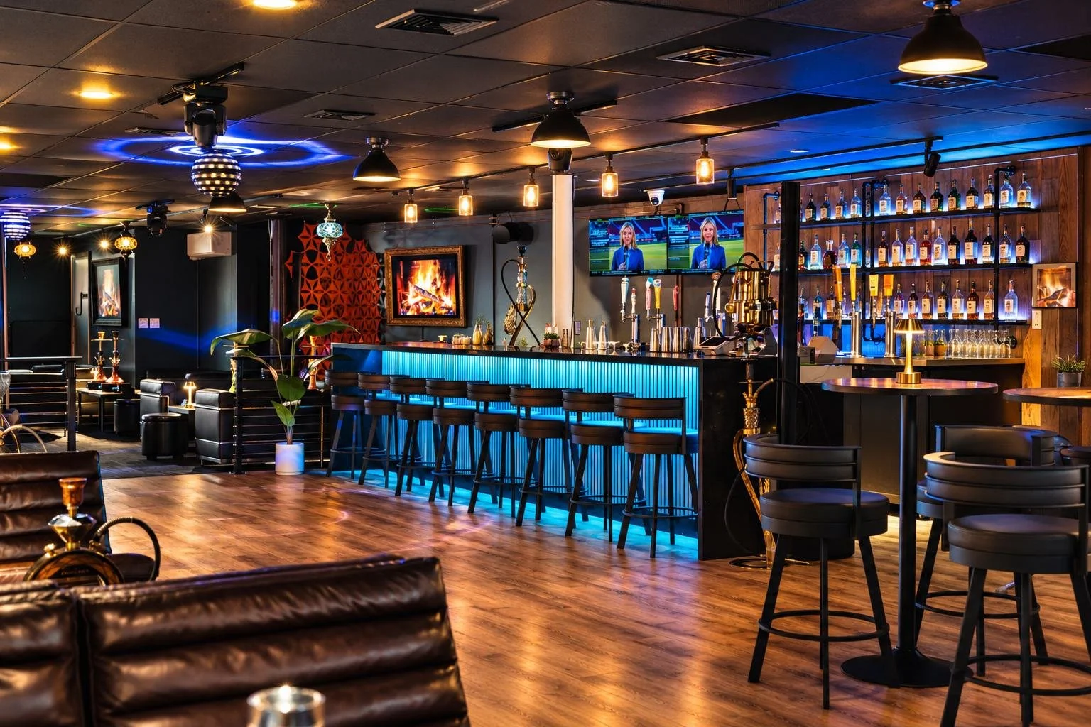 Commercial interior photography: sports bar with neon blue lighting and wood floors
