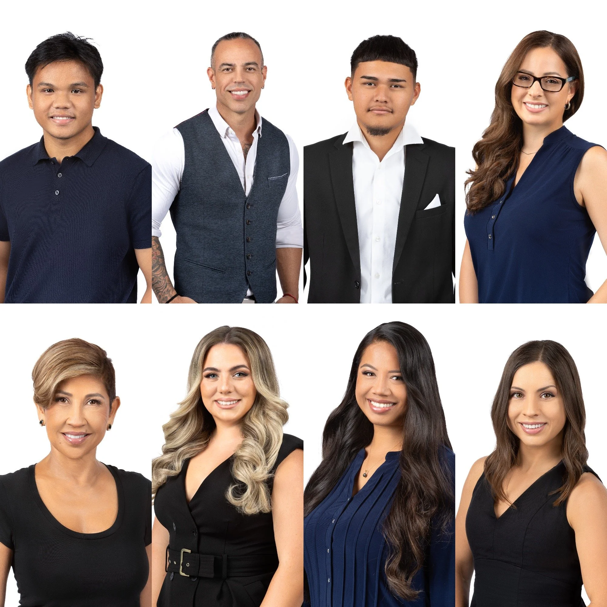 Group of four diverse adults in business attire smiling against white background.