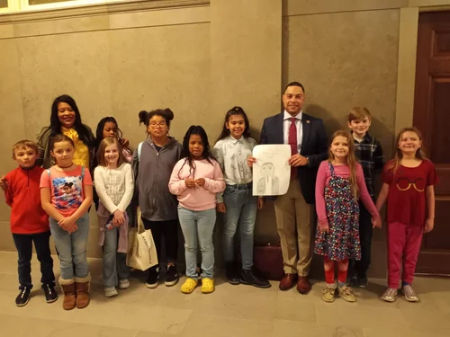 A group of past UBC Ambassadors with two adults at the Missouri State Capitol