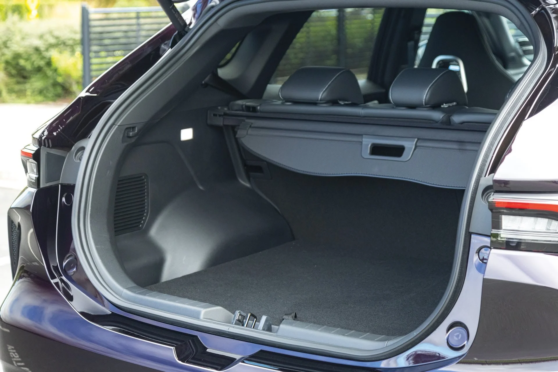 Open trunk of a modern SUV showing empty cargo space and rear seats.