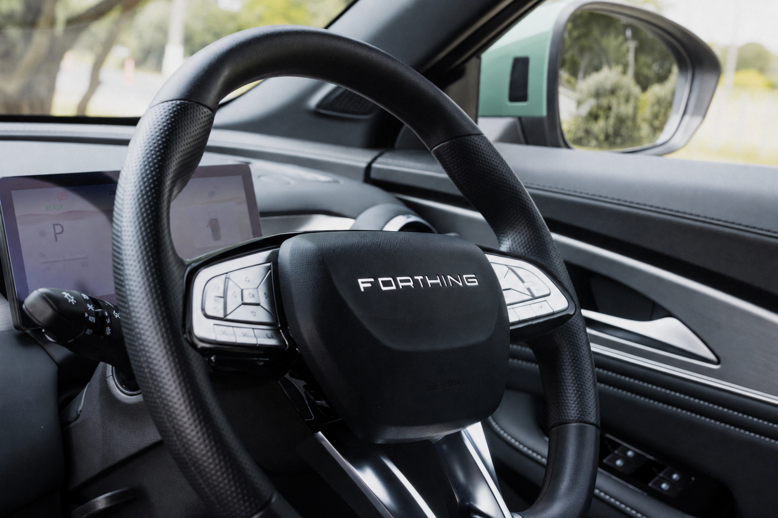 Close-up of the steering wheel of a futuristic vehicle with 'FORTHING' branding, digital dashboard display, and control buttons in the interior.