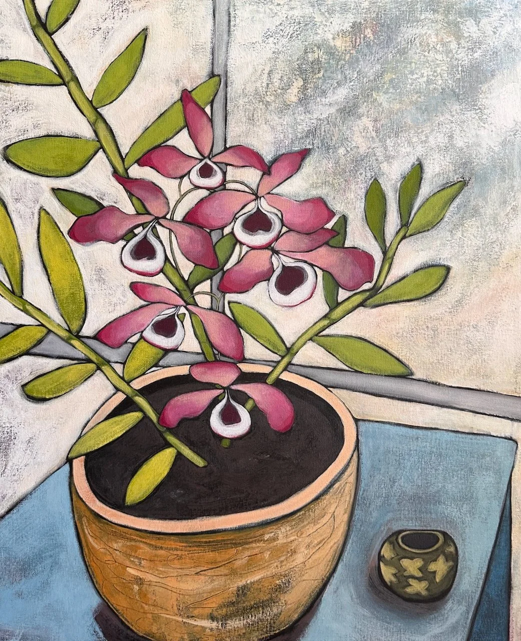Painting of a potted pink and white orchid plant on a blue table next to a small decorative vase.