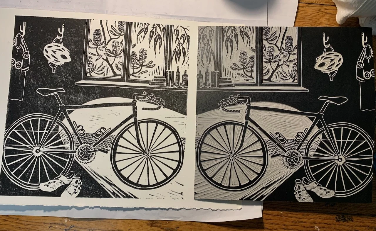 Black and white sketch of a bicycle on a table with a window and plants in the background.