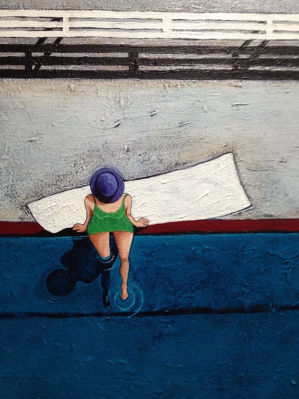 A mural of a woman in a green swimsuit and purple hat sitting on a dock, with her feet in the water.