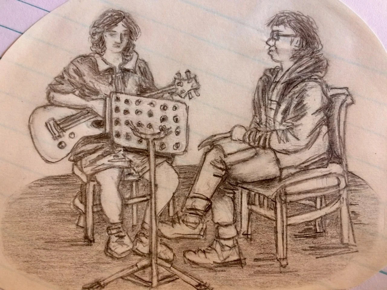 A pencil sketch of two people sitting indoors. One person is playing an acoustic guitar and reading music from a stand, while the other person is sitting on a chair, listening attentively.