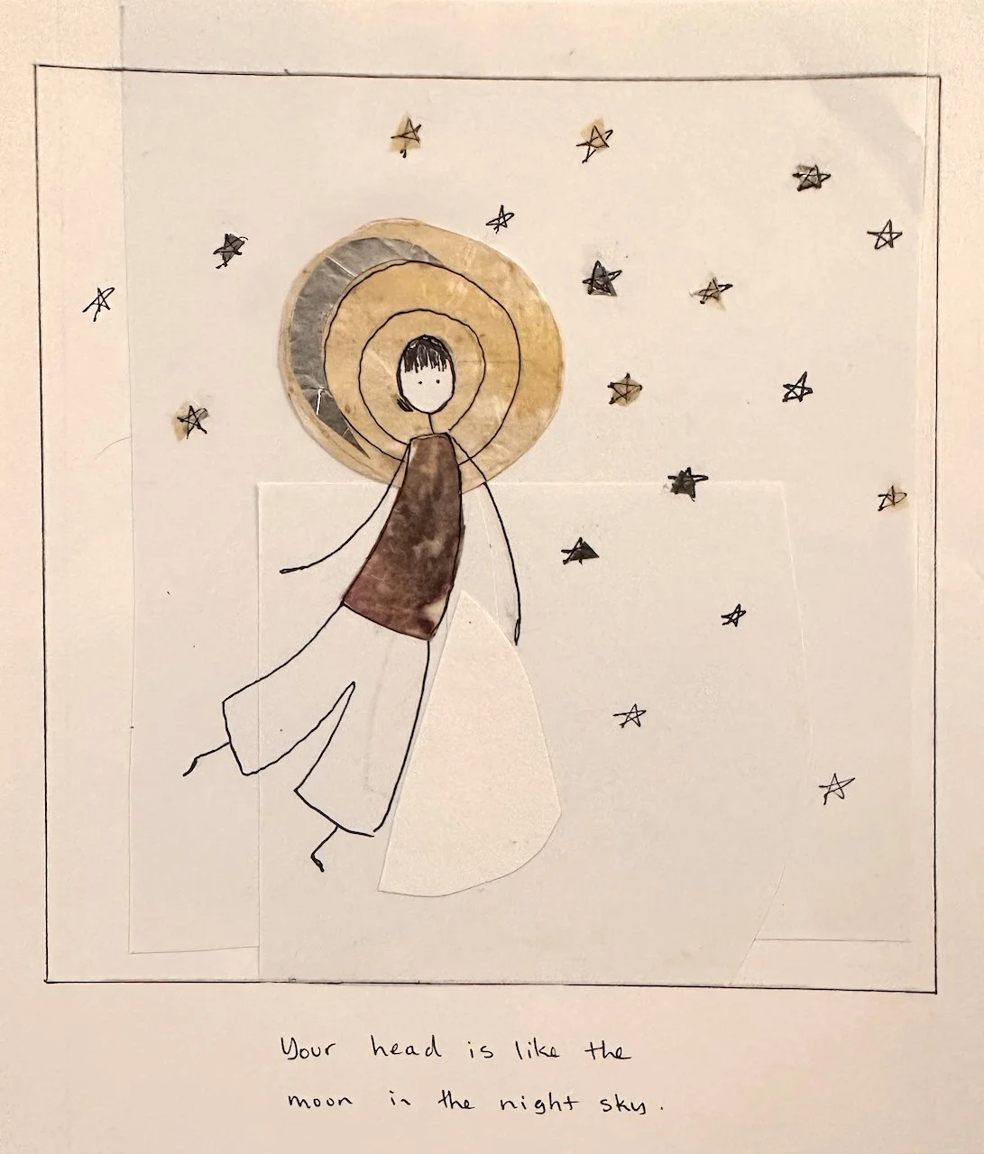 A drawing of a person with a halo-like circle around their head, surrounded by stars, with a handwritten note below that says "Your head is like the moon in the night sky."