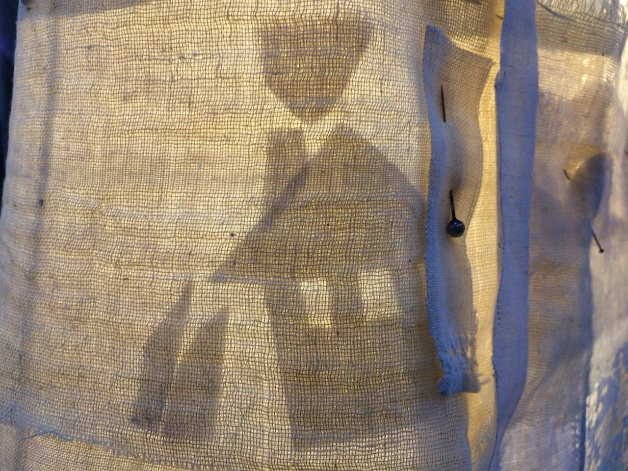 A shadow of a house on fabric.