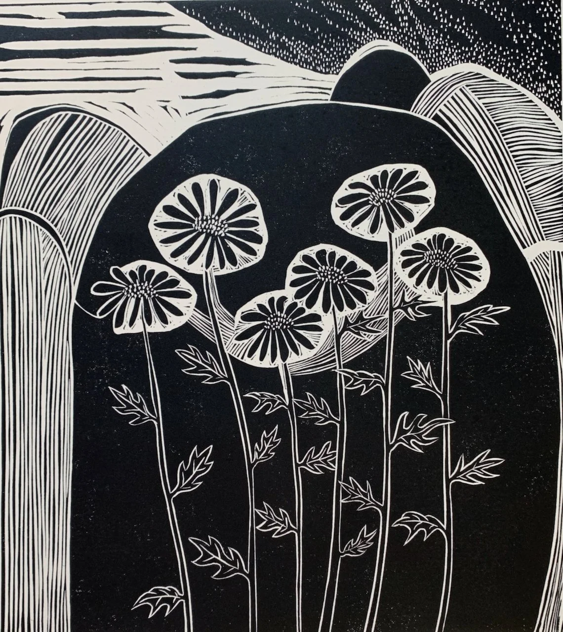 Black and white abstract illustration of flowers with round petals and stems, surrounded by curved lines and patterns.