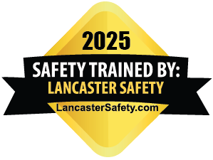 Safety training badge with yellow diamond shape, the year 2025 at the top, black and white text stating 'Safety Trained by: Lancaster Safety' and the website LancasterSafety.com.