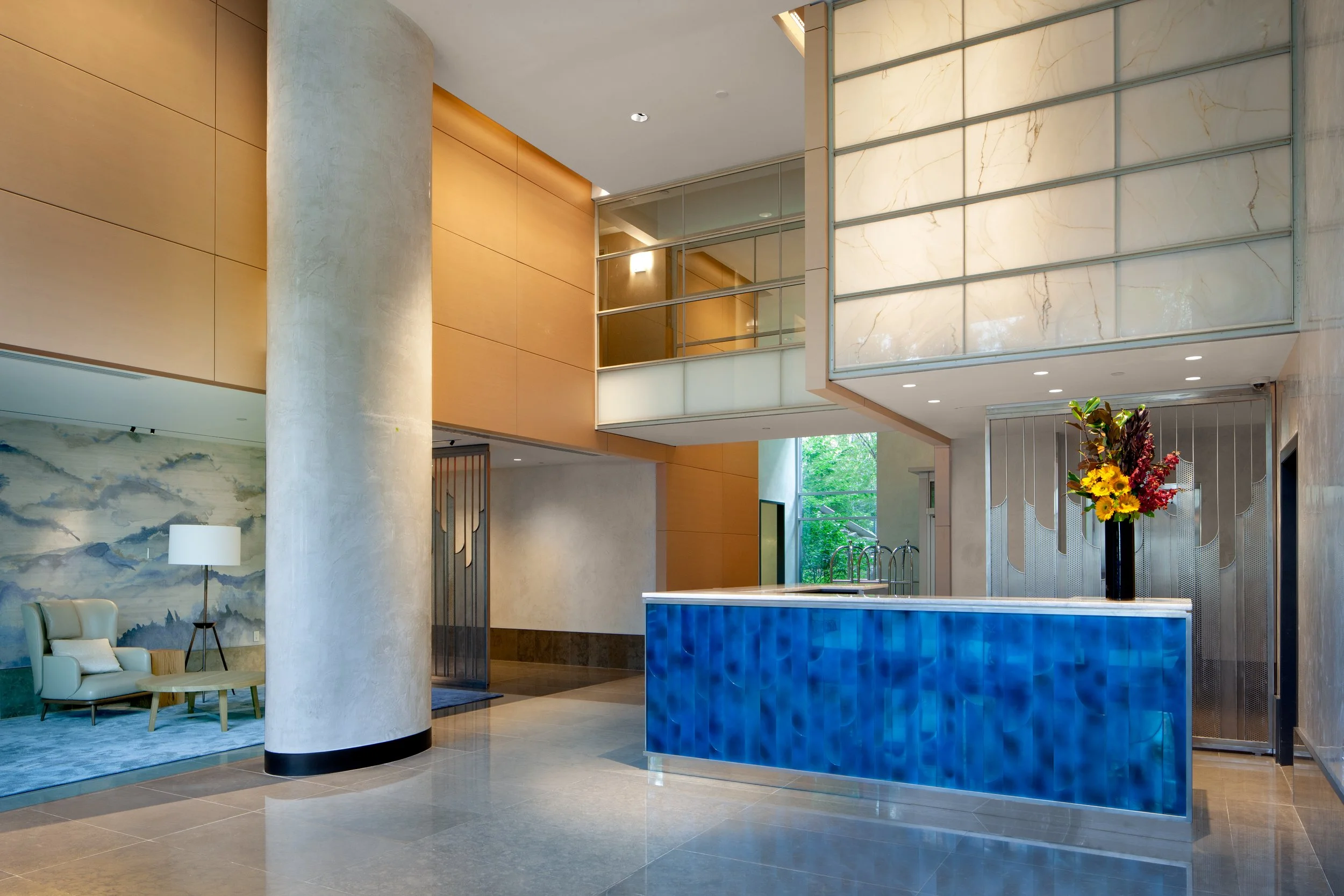 Unique cobalt blue reception desk in a double-height lobby in Battery Park City in Manhattan