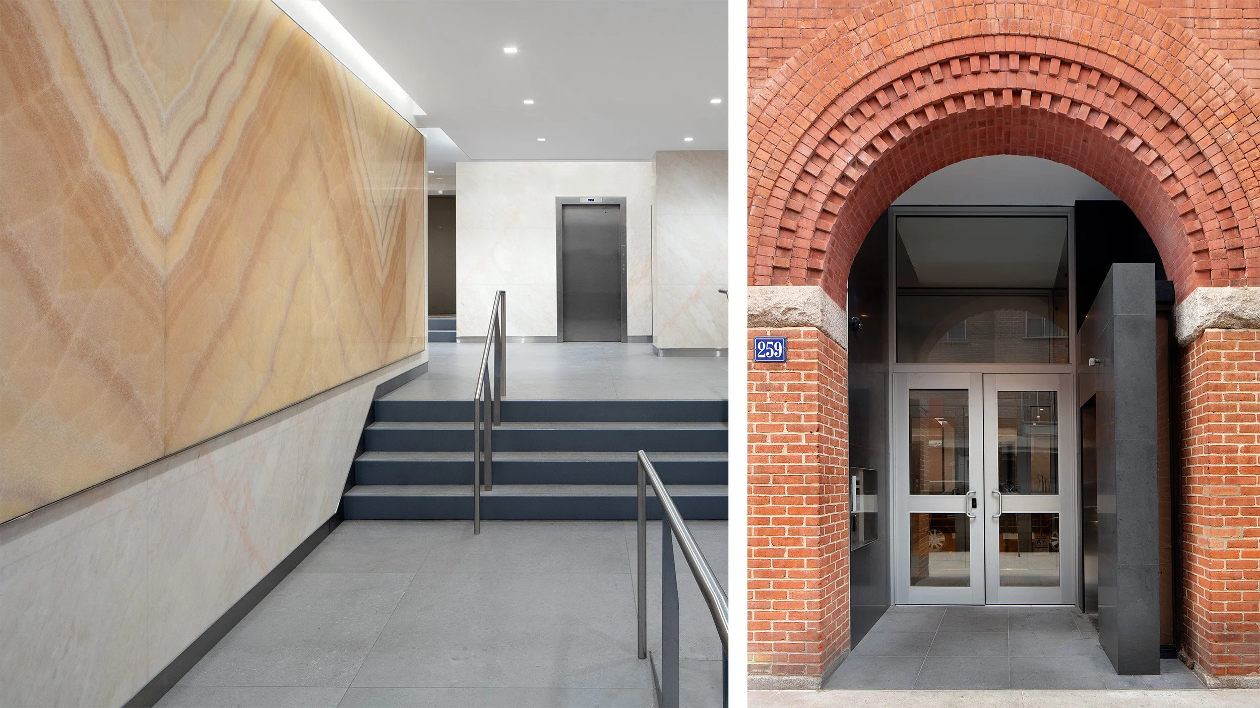 Modern glass double doors at the entrance of a brick building with an arched brick entryway and stone accents.