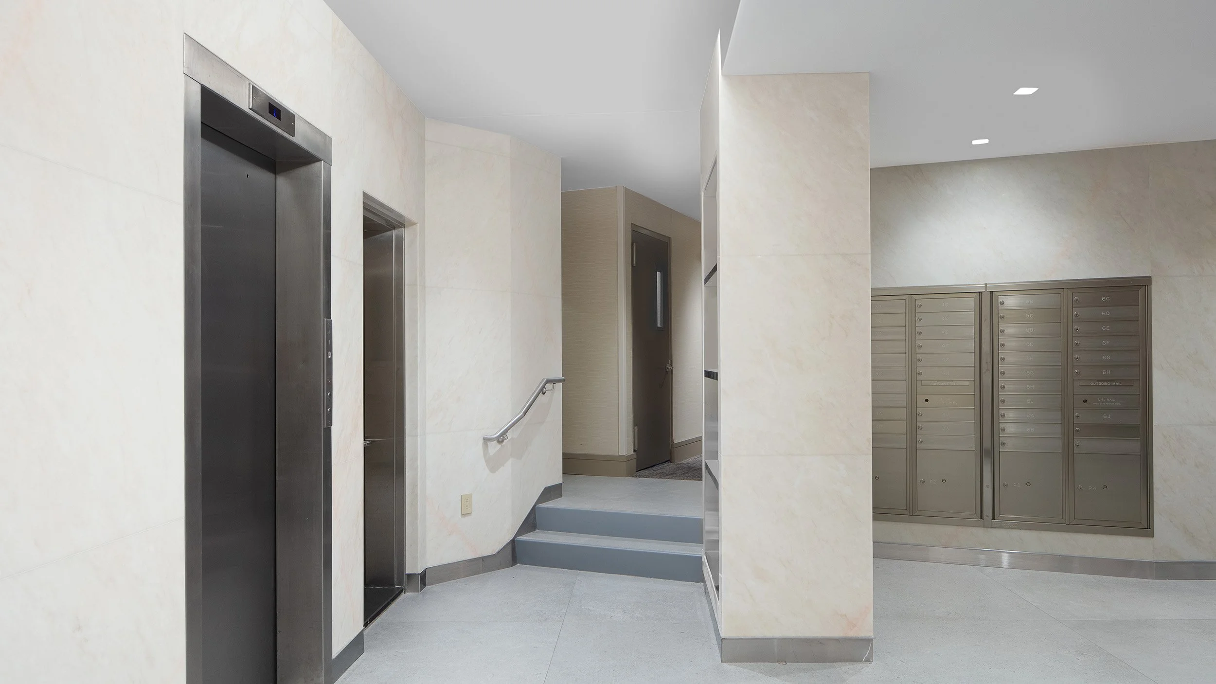 P661 Marble and steel lobby with elevator bank and mailbox wall
