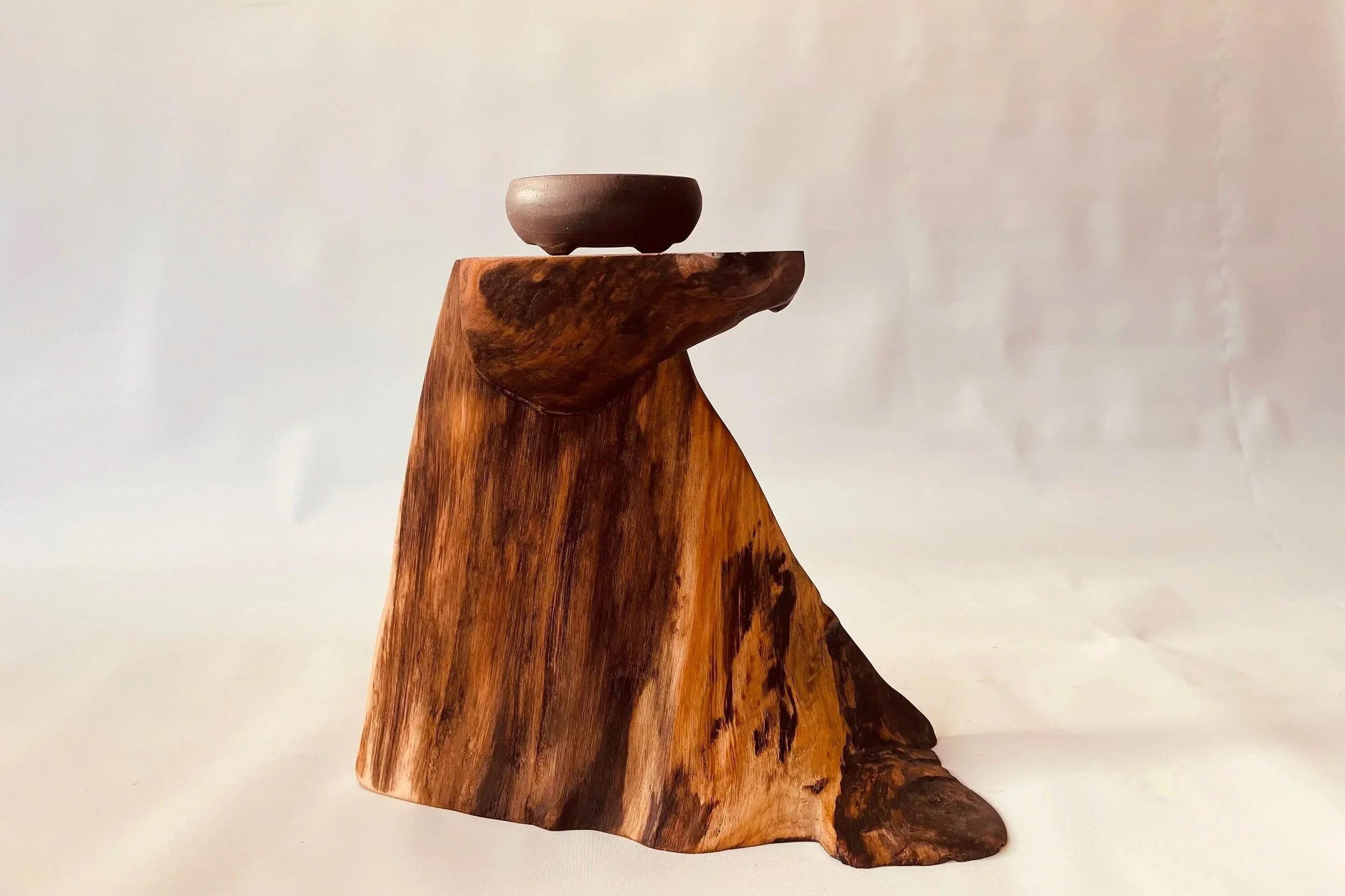 A rustic cascade style bonsai stand resembling a mountain