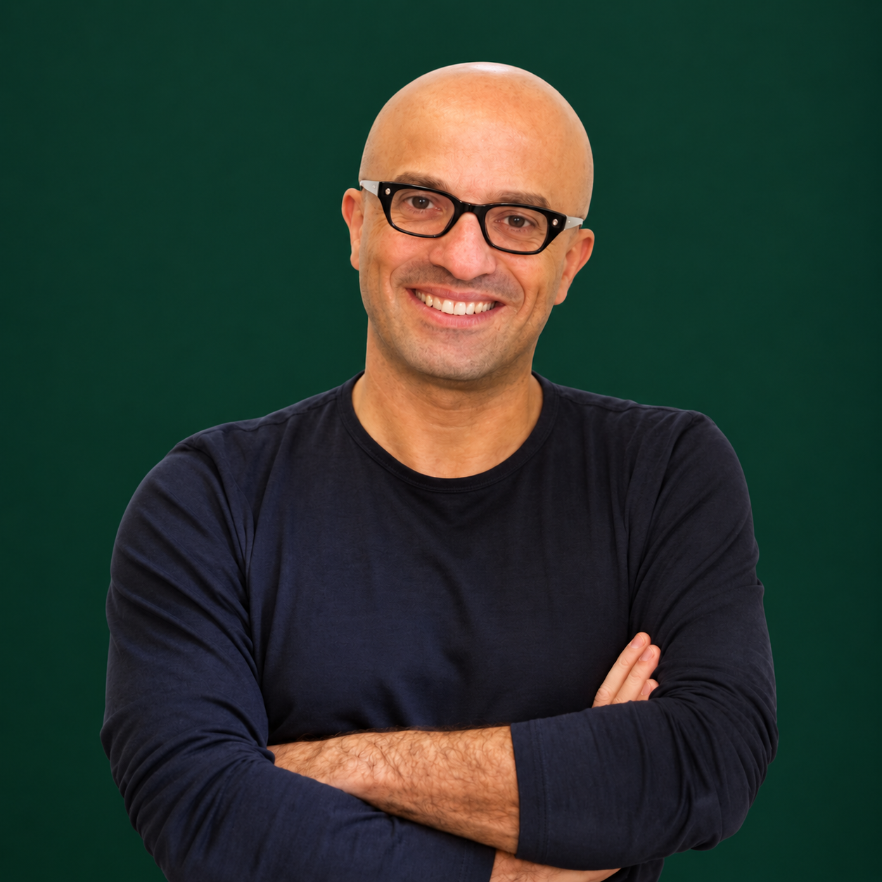 Headshot of smiling male tutor with medium-length black hair wearing a lanyard.