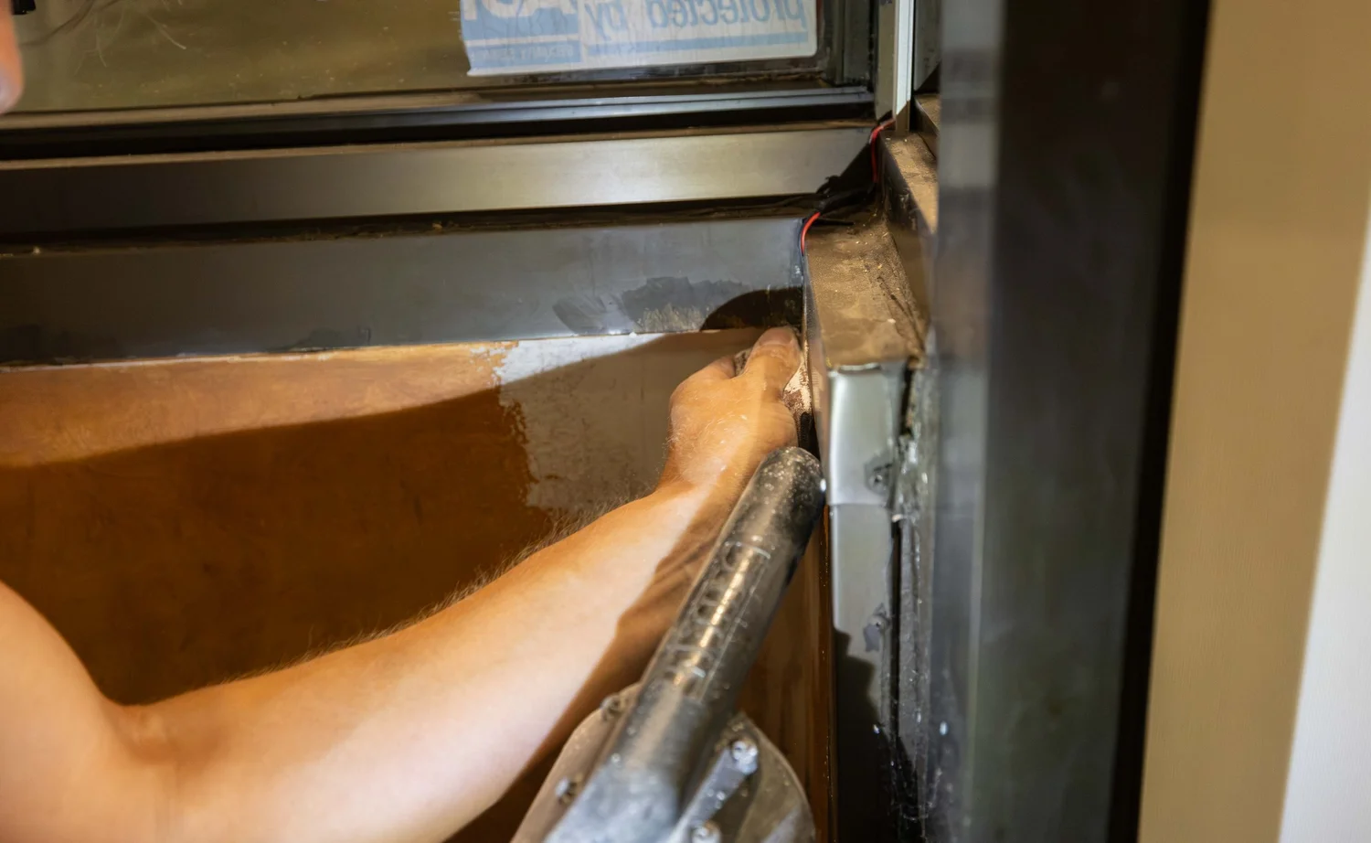 Close-up of wall repair along a window frame during a commercial refresh in Etobicoke