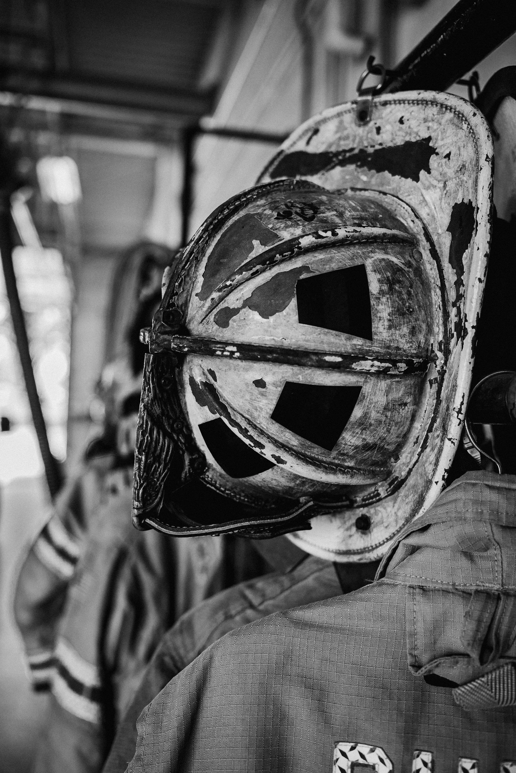 Close-up of a person wearing a protective helmet, possibly a firefighter or industrial worker, with a blurred background.