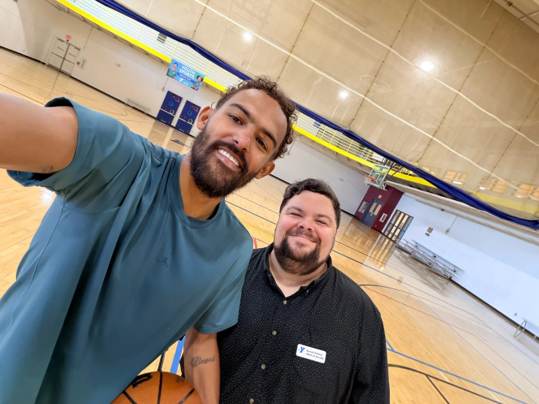 Garrett with basketball player Trae Young during a YMCA video production
