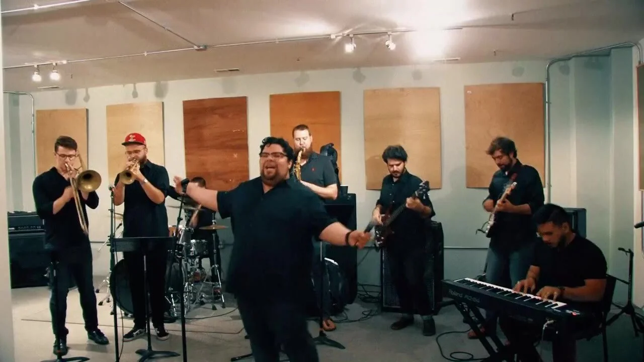 Garrett singing with a live band during a performance