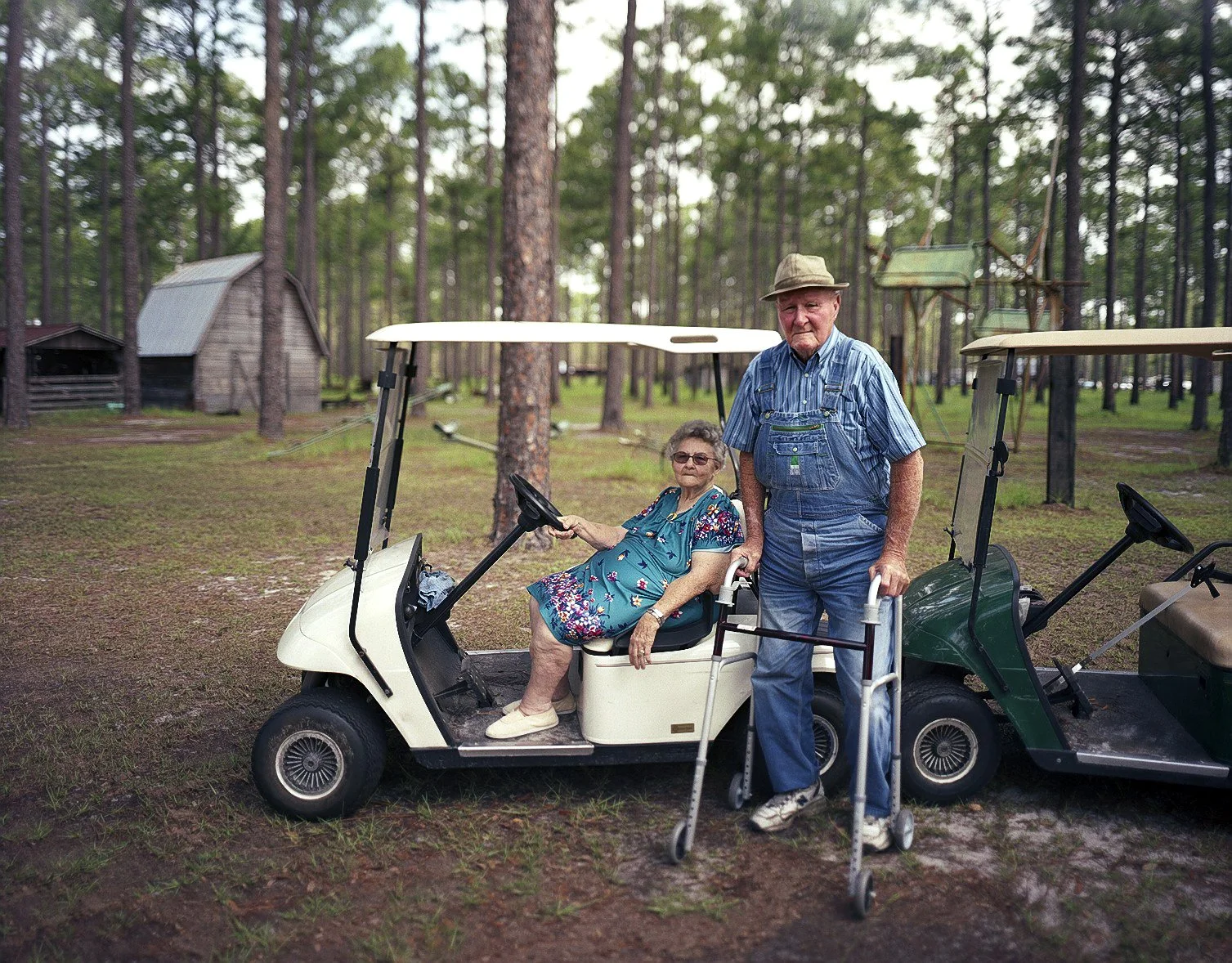 James and Martha Davis, standing in front of the replica southern town they built