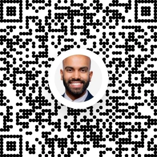 QR code with a circular profile picture of a smiling man with a beard at the center.