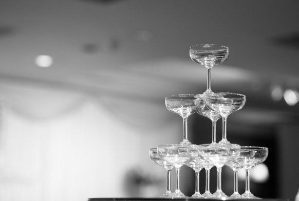 A pyramid of empty champagne glasses stacked in a triangle shape.