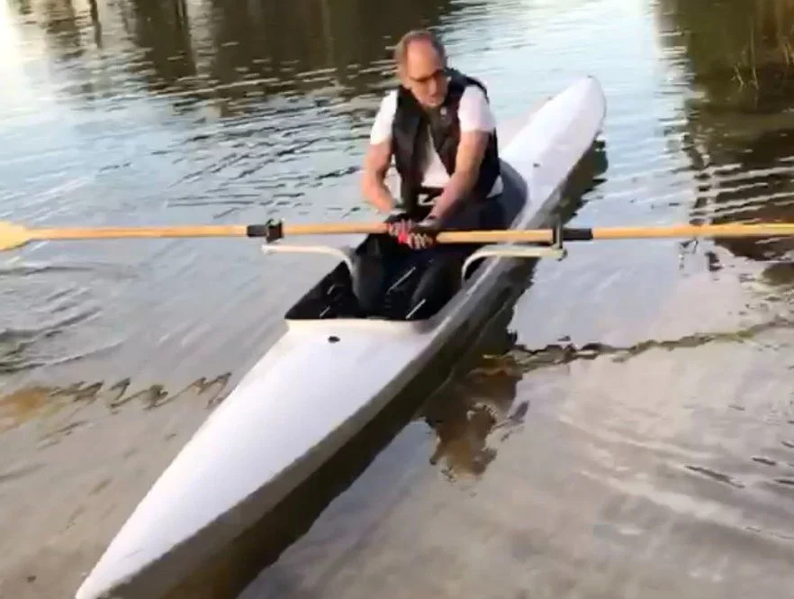 Dr. Jones rowing on a quiet river