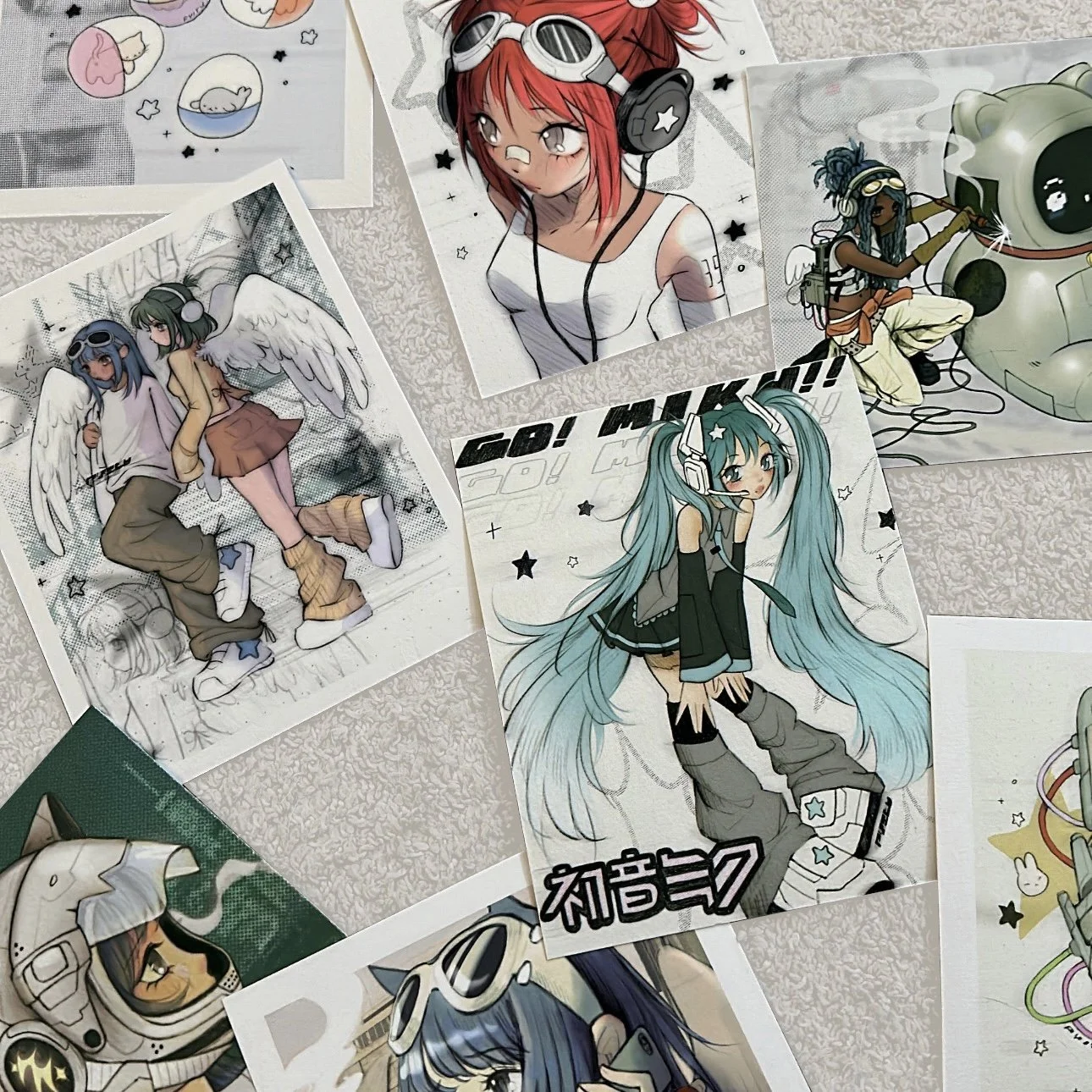 Collection of anime-style character illustrations on paper, featuring girls with colorful hair and themed outfits, with science fiction and fantasy elements.