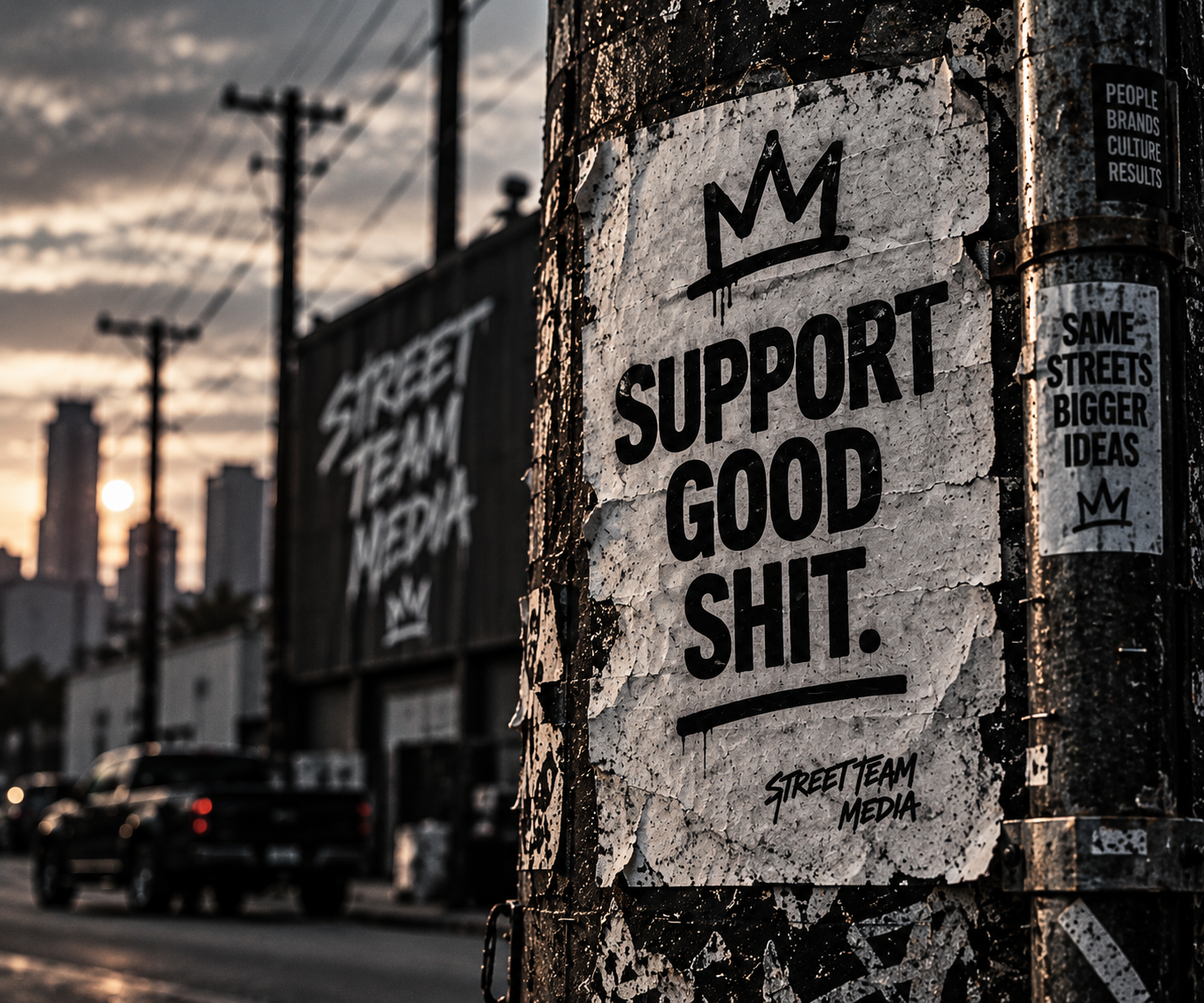 Poster on a pole with the text "Support Good Shit." with a crown symbol above, set against a city street at sunset.