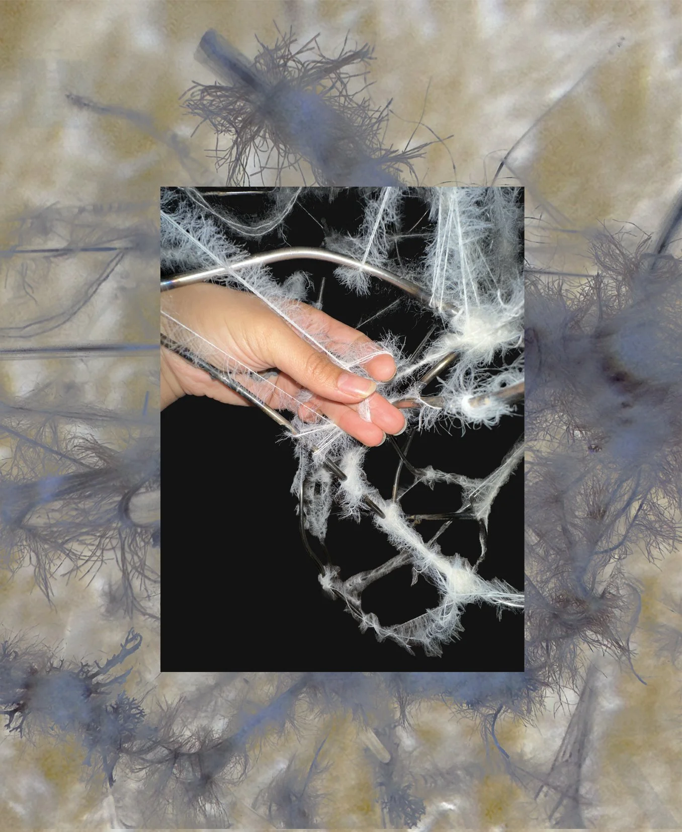 Close-up of a person's hand holding a thread, working on a delicate mycelium sculpture with internet-like webbing.